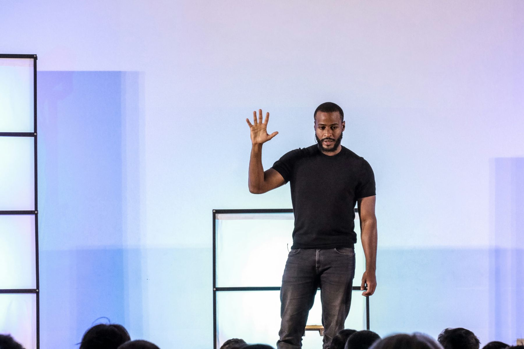 Man presenting on a large stage